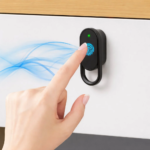 A sleek silver and black smart lock installed on a wooden office drawer.