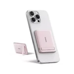 Pink Baseus PicoGo AM31 magnetic power bank attached to a phone using its built-in kickstand.