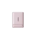 Pink Baseus PicoGo AM31 magnetic power bank attached to a phone using its built-in kickstand.