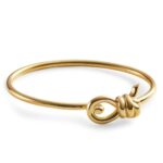 Close-up of the Bottega Veneta Knot Bracelet featuring the gold knot motif that is its signature.