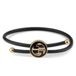 Gucci Interlocking G logo bracelet with black enamel and leather strap