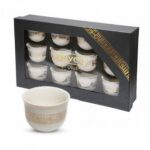 Set of 12 traditional white Arabic coffee cups arranged on a serving tray